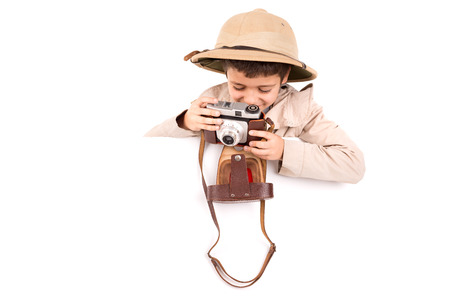 Young boy with camera playing Safari isolated in white