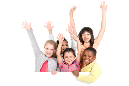 Group of children with a white board isolated in whiteの写真素材