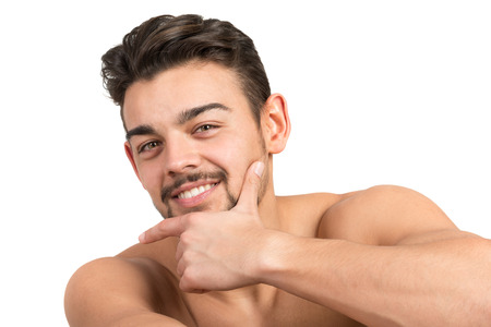 Handsome and muscular young man posing isolated in whiteの写真素材