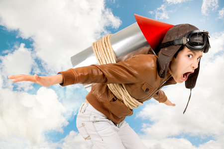 Young boy with home made rocket ready for adventureの写真素材
