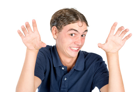Teenager boy making happy faces isolated in whiteの写真素材