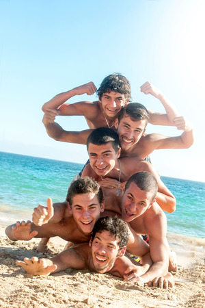Group of happy boys at the beachの写真素材