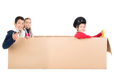 Children playing VIP people in a cardboard box limousineの写真素材