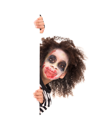 Young girl Zombie with face-paint in Halloween over a white boardの写真素材