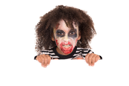 Young girl Zombie with face-paint in Halloween over a white board