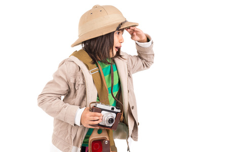 Young girl with a camera playing Safari isolated in whiteの写真素材