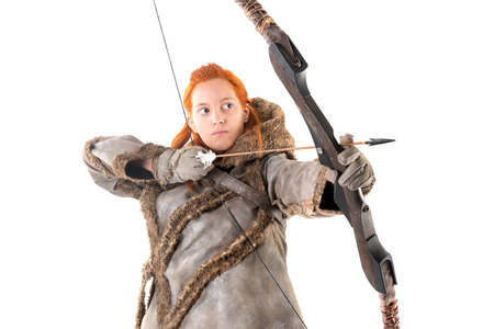 girl archer in a costume with bow isolated in whiteの写真素材