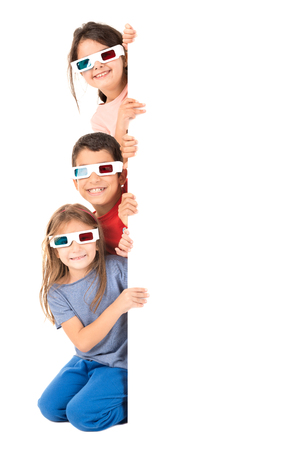 Group of children with 3d glasses over a white boardの写真素材