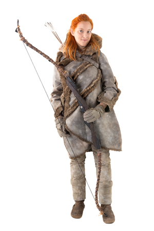 girl archer in a costume with bow isolated in whiteの写真素材