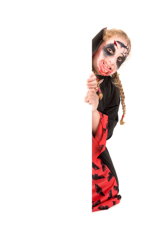 Girl with face-paint and vampire Halloween costume isolated in whiteの写真素材