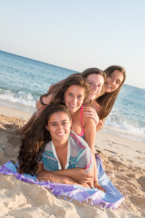 Group of happy teenage girls at the beachの写真素材