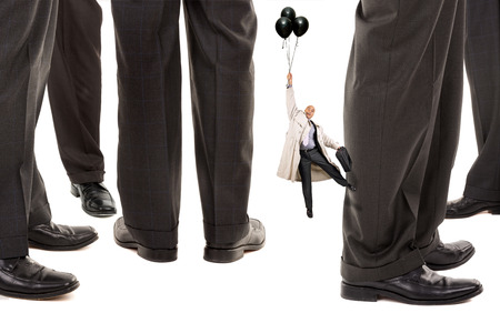 Small businessman trying to reach big business playersの写真素材