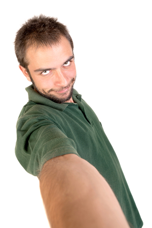 Young man taking a selfie isolated in whiteの写真素材