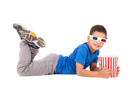 Young boy with 3d glasses and popcorn isolated in white