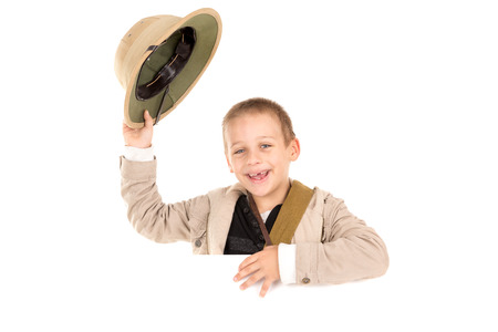 Young boy holding Safari hat isolated in whiteの写真素材