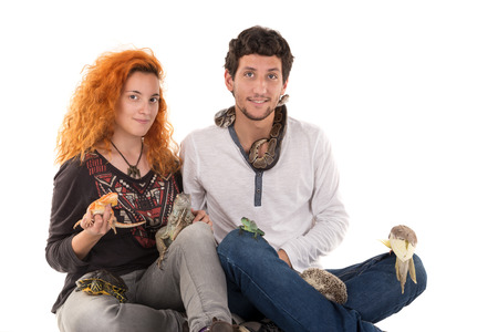 Couple with several pet animals isolated in whiteの写真素材