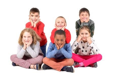 Group of happy children posing isolated in whiteの写真素材