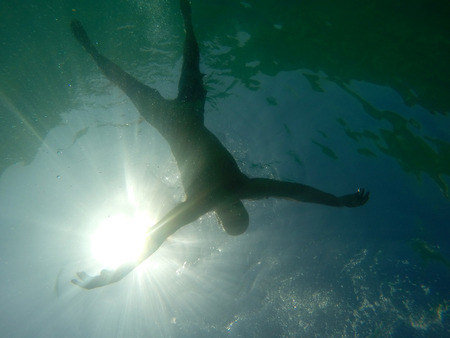Man drowning viewed from below underwater