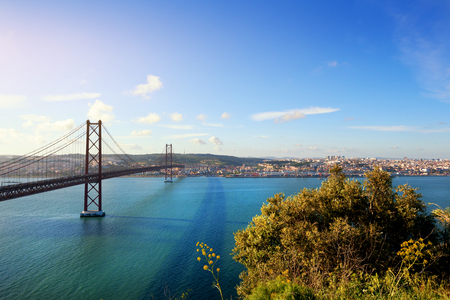 "25 de Abril" bridge in Lisbon Portugal at sunsetの写真素材
