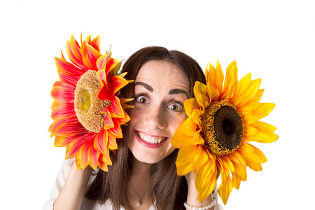 Casual young woman with flowers isolated in a white backgroundの写真素材