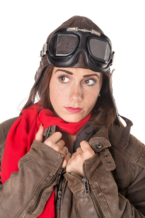 Beautiful girl with freckles wearing helmet, goggles and a red scarfの写真素材