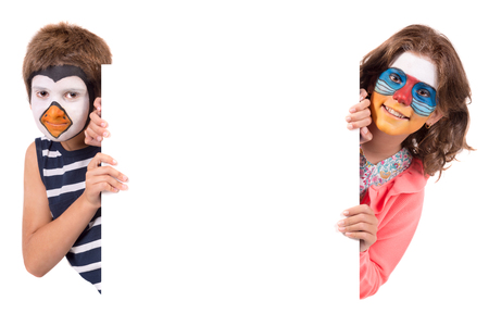 Children's couple with animal face-paint isolated in whiteの写真素材