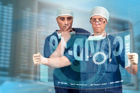 Doctors researching Corona virus cure, with digital screensの写真素材