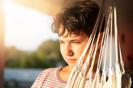 Handsome boy posing outdoors at sunsetの写真素材