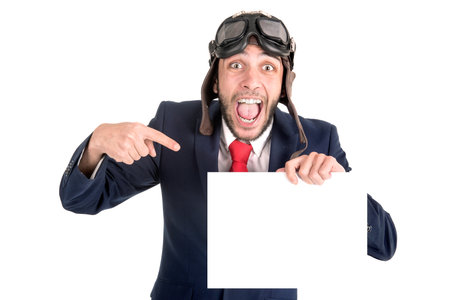 Businessman with pilot goggles and white board isolated in whiteの写真素材