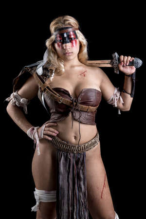 Ancient woman warrior or Gladiator posing in a dark backgroundの写真素材