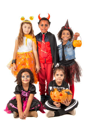 Group of kids in Halloween/Carnaval costumes isolatedの写真素材