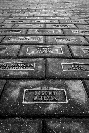 Cobblestone street with engraved Holocaust victims names in Lodz, Poland