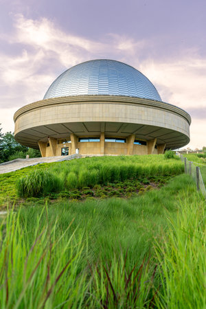 Vertical View of Chorzow Planetarium Dome at Sunset with Tall Grass, In Poland