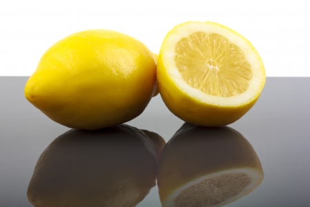 Fresh ripe lemons with halfの写真素材