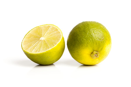 Limes with slices isolated on white background