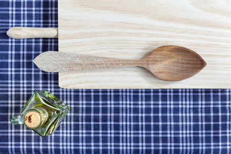 table and wooden spoon on a blue tableclothの写真素材