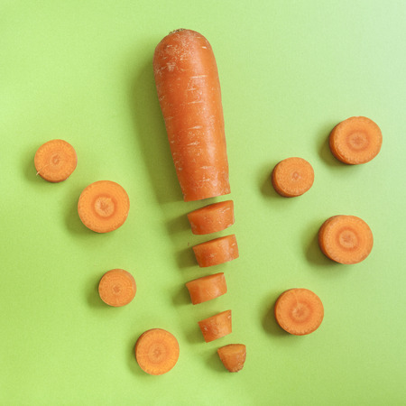 set of carrots on a green countertop