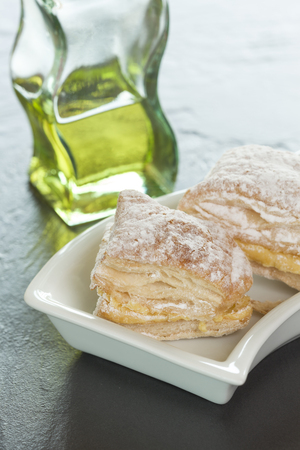 Puff pastry cake with cream and powdered sugarの写真素材