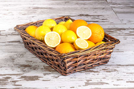 Lemons ans oranges in a wicker basketの写真素材