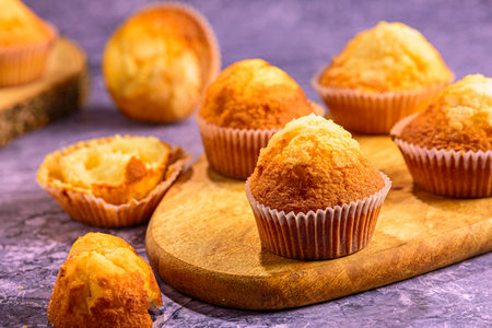 Muffins on a wooden cutting board. Selective focus.