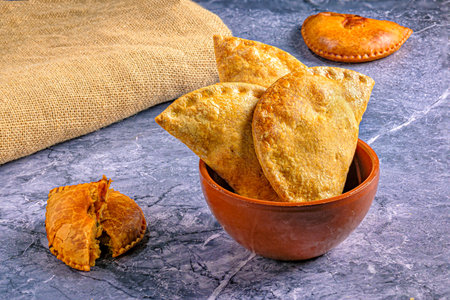 Appetizing empanadas in an earthenware bowl