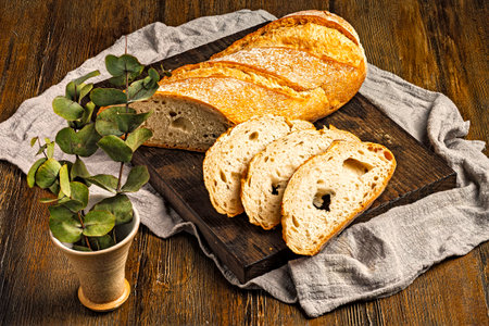 Sliced baguette and eucalyptus branch