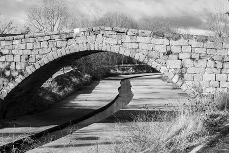 antique roman bridge made with stones in Avila, Spainの写真素材