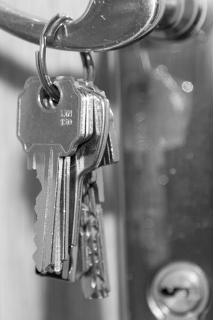 Bunch of keys holding in the doorの写真素材