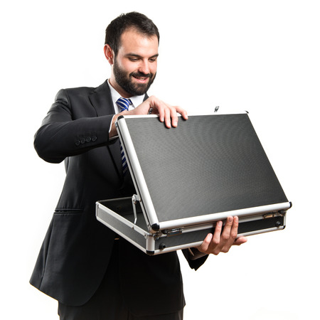 Young businessman open his briefcase over white backgroundの写真素材