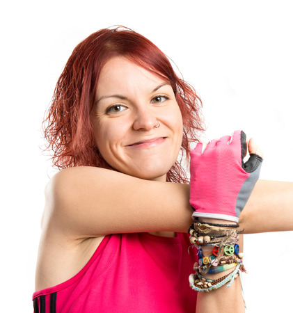 Young sport girl stretching over white backgroundの写真素材