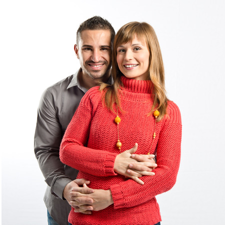 Happy couple over isolated white background の写真素材