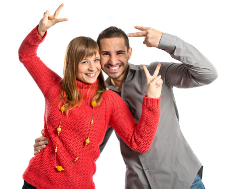 Couple making Ok sign over white background の写真素材