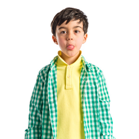 Boy making a mockery over isolated background の写真素材