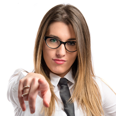 Young pretty businesswoman pointing over white background の写真素材